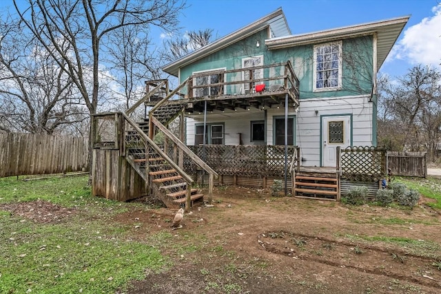206 M L K Dr Unit B, Elgin, TX 78621 - back of property featuring stairway and a wooden deck