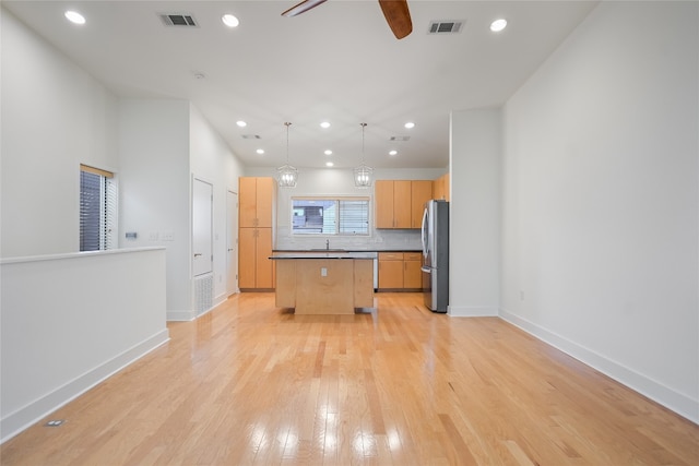 1702 S Lamar Blvd Unit 22, Austin, TX 78704 - kitchen featuring freestanding refrigerator, a center island, ceiling fan, light wood-type flooring, and recessed lighting