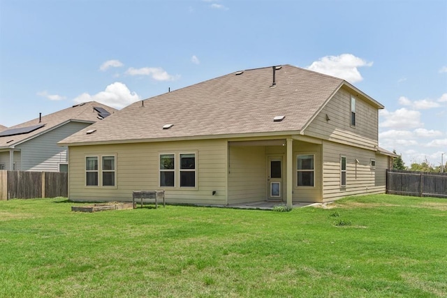 back of property featuring a lawn