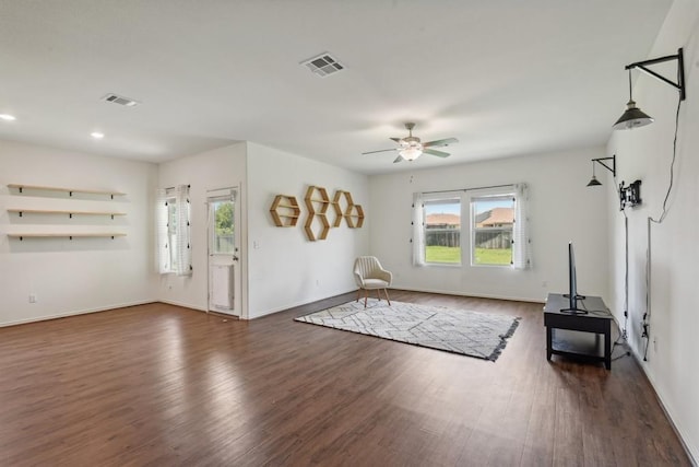 unfurnished living room featuring dark hardwood / wood-style flooring and ceiling fan