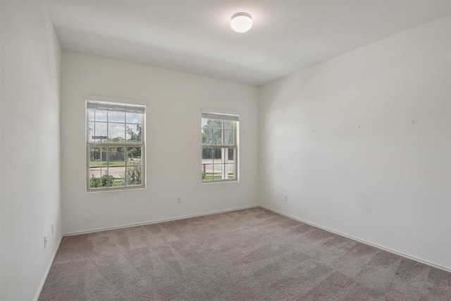 unfurnished room with light colored carpet