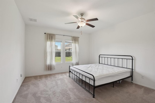 bedroom featuring light carpet and ceiling fan