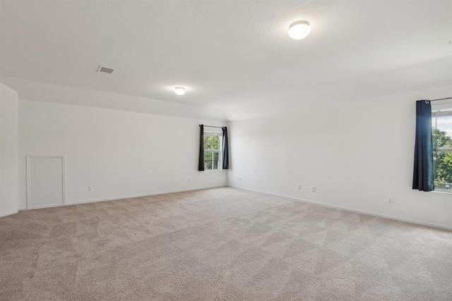 carpeted spare room with a healthy amount of sunlight