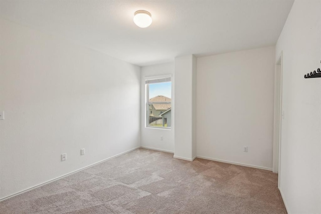 unfurnished room featuring light colored carpet