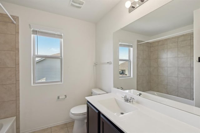 full bathroom featuring tiled shower / bath, tile patterned floors, toilet, and vanity