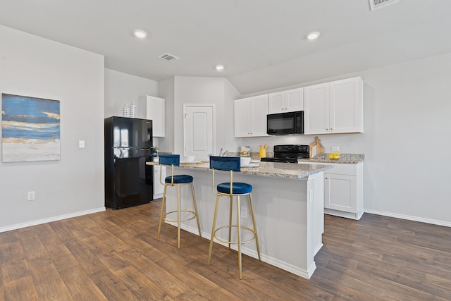 kitchen with light stone countertops, black appliances, white cabinets, a center island with sink, and dark hardwood / wood-style flooring