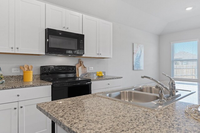 kitchen featuring vaulted ceiling, sink, white cabinets, and black appliances