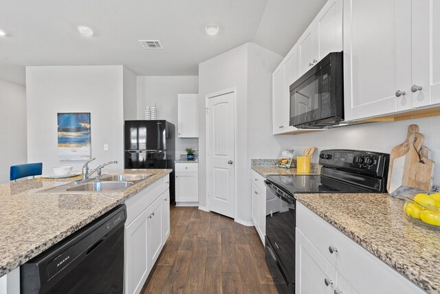 kitchen with white cabinetry, sink, light stone counters, and black appliances