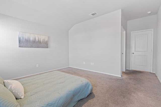 bedroom with lofted ceiling, visible vents, baseboards, and carpet flooring