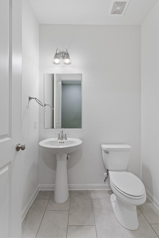 bathroom with tile patterned flooring and toilet