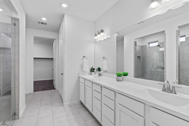 bathroom featuring vanity, tile patterned floors, and walk in shower