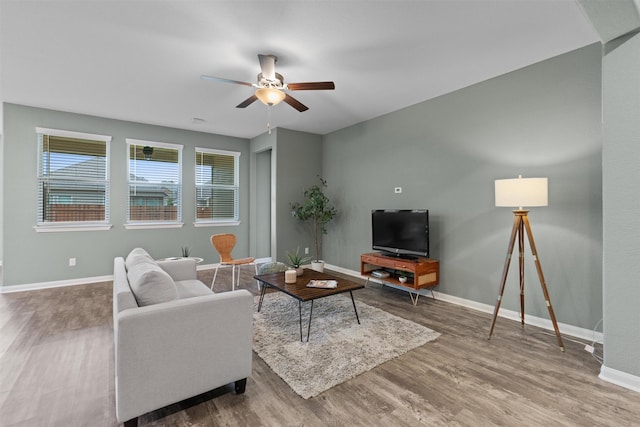 living room with hardwood / wood-style flooring and ceiling fan