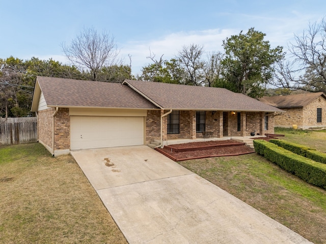 ranch-style home with a garage and a front yard