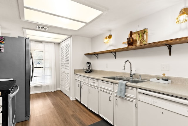 kitchen featuring sink, stainless steel electric range, dishwasher, dark hardwood / wood-style floors, and white cabinets