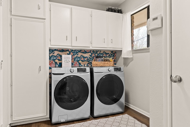 laundry room featuring cabinets, separate washer and dryer, and dark hardwood / wood-style flooring