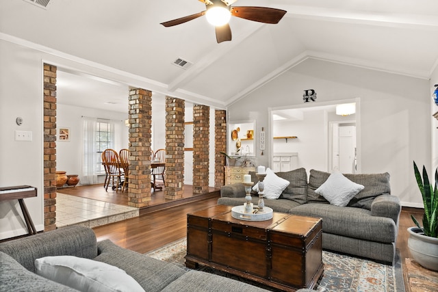 living room with wood-type flooring, vaulted ceiling, and ceiling fan