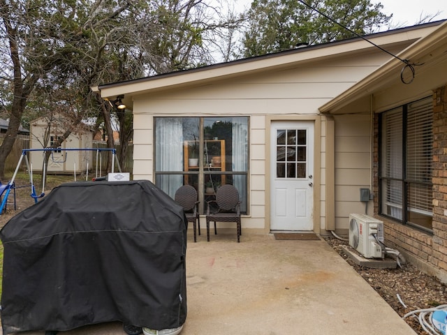 view of patio / terrace featuring ac unit, a grill, and a trampoline