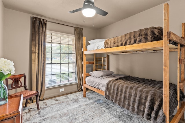 bedroom featuring multiple windows and ceiling fan