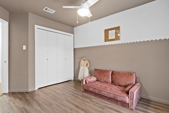 living area featuring ceiling fan and light wood-type flooring