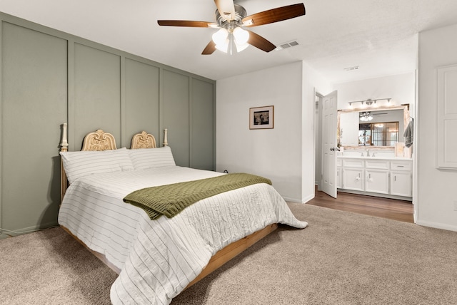 carpeted bedroom featuring ceiling fan and connected bathroom