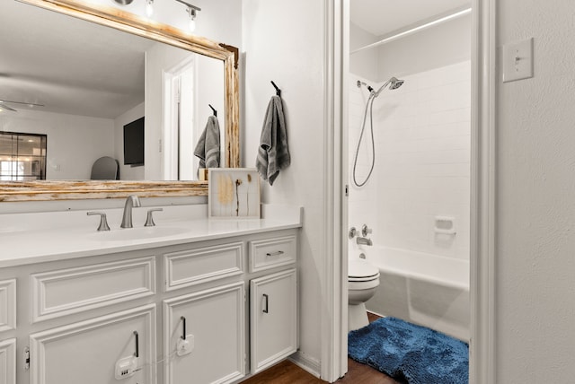 full bathroom featuring shower / tub combination, wood-type flooring, vanity, and toilet