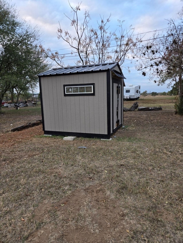 view of outdoor structure featuring a lawn