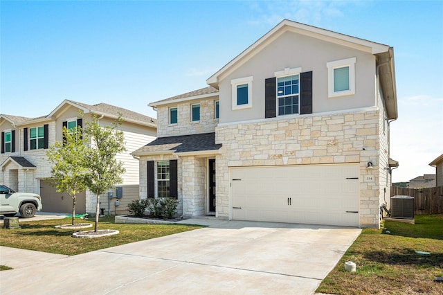 view of front of home with a garage, central AC unit, and a front lawn