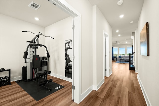 workout area with hardwood / wood-style floors and ceiling fan