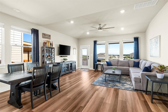 living room with hardwood / wood-style flooring, vaulted ceiling, and ceiling fan