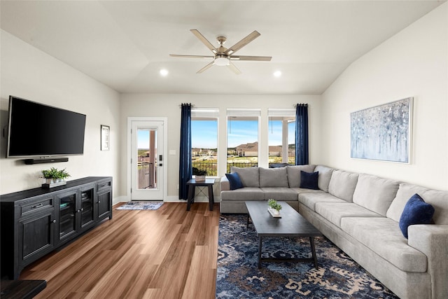 living room with lofted ceiling, hardwood / wood-style floors, and ceiling fan