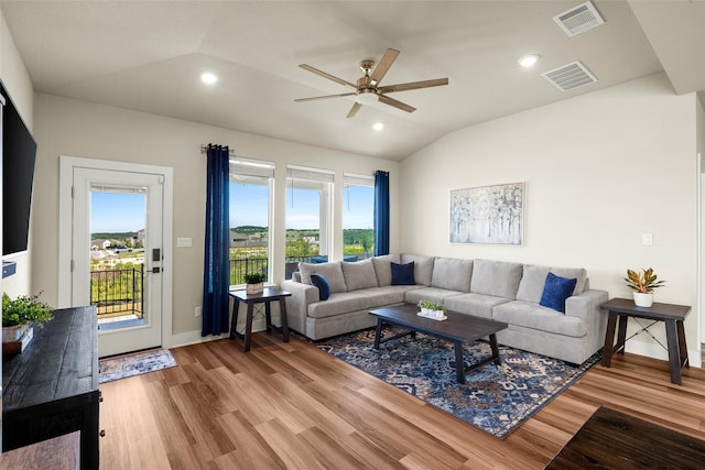 living room featuring lofted ceiling, hardwood / wood-style floors, and ceiling fan