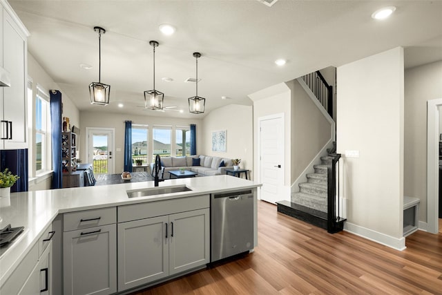 kitchen featuring gray cabinets, dishwasher, sink, and hanging light fixtures