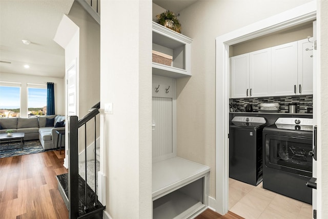 mudroom featuring light hardwood / wood-style floors and washing machine and clothes dryer