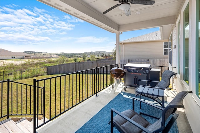 exterior space with grilling area and ceiling fan