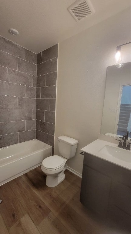 full bathroom with vanity, toilet, wood finished floors, and visible vents