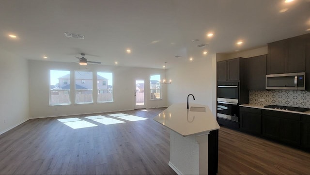 kitchen featuring a sink, visible vents, plenty of natural light, and black appliances