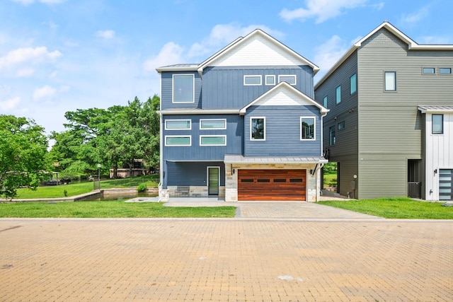 view of front of house with a garage and a front yard