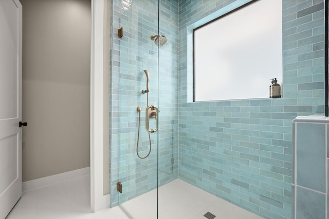 bathroom with tile patterned floors and a shower with shower door