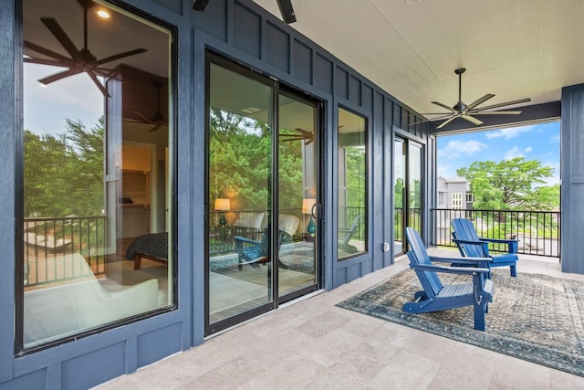 unfurnished sunroom with ceiling fan