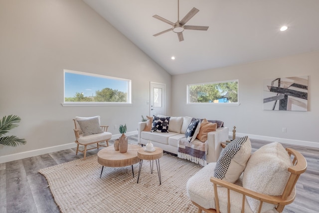 living room featuring ceiling fan, high vaulted ceiling, and light hardwood / wood-style floors