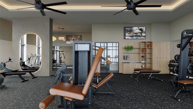 gym with ceiling fan and a towering ceiling