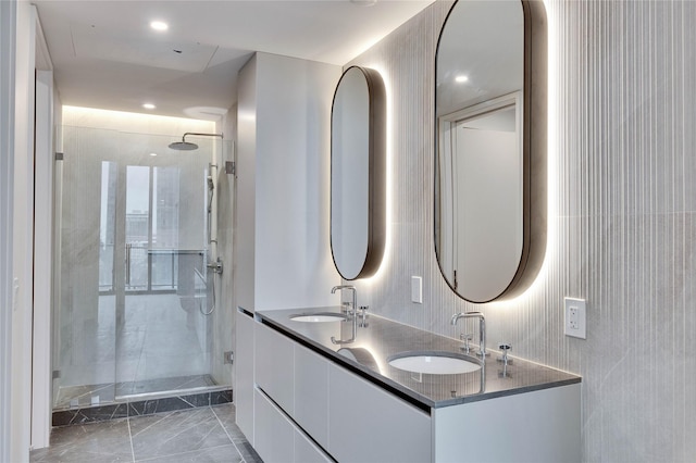 bathroom with vanity and a tile shower