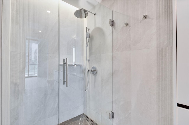 bathroom featuring a shower with shower door