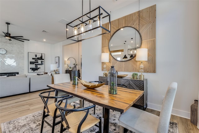 dining area with ceiling fan and light hardwood / wood-style floors