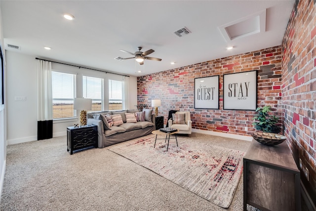 carpeted living room with brick wall and ceiling fan