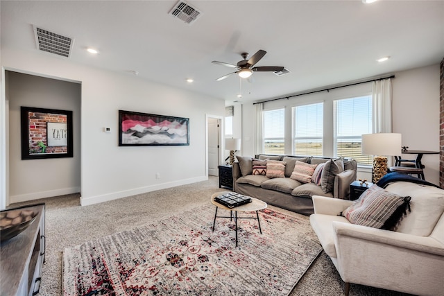 living room featuring ceiling fan and light colored carpet