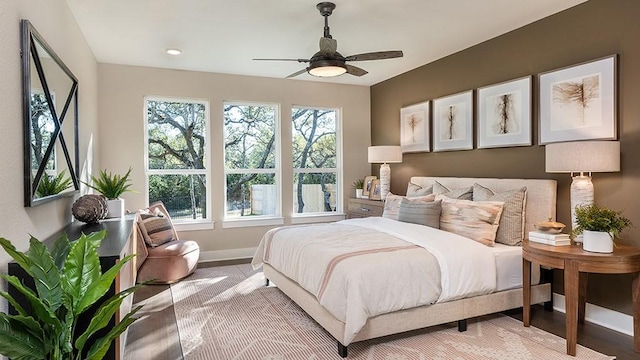 bedroom featuring light hardwood / wood-style flooring and ceiling fan