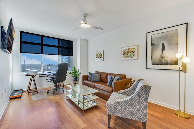 living room with ceiling fan and wood-type flooring