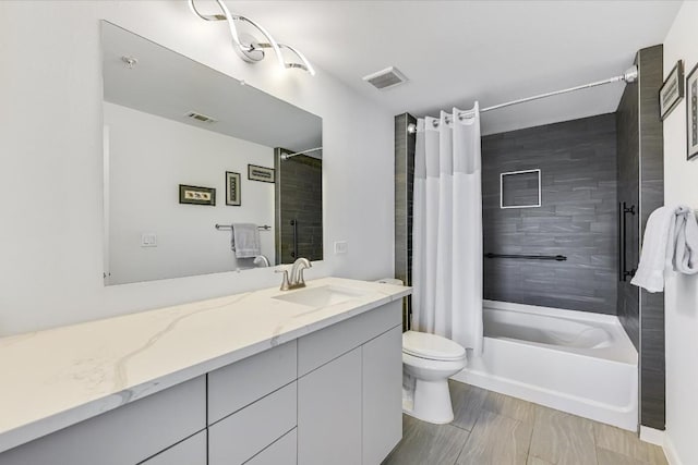 full bathroom with vanity, shower / bath combination with curtain, and toilet