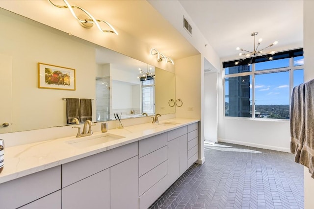 bathroom with walk in shower, vanity, and a notable chandelier